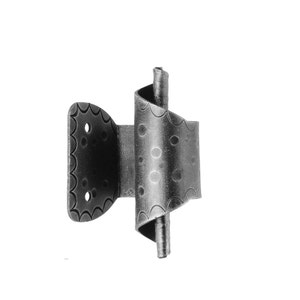 May include: A black metal hinge with a decorative swirl design. The hinge has a textured surface and a scalloped edge.