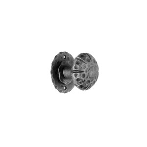 May include: A black metal door knob with a hammered finish. The knob is round and has a textured surface.