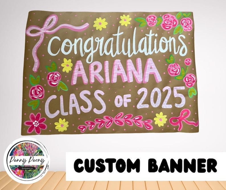 May include: A custom banner with the words "congratulations ARIANA CLASS OF 2025" in white and pink lettering. The banner is decorated with pink flowers, yellow flowers, and pink bows on a brown background.