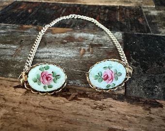 Vintage white, pink & green floral guilloche and gold tone oval shaped 1960’s style sweater clip/guard