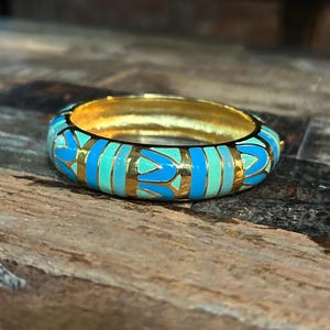 Vintage Joan Rivers gold tone and shades of  blue and green enamel hinged bangle bracelet