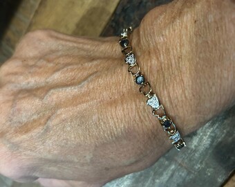 Sparkly 7 1/4 inch 925 sterling with gold overlay heart shaped link tennis bracelet with dark stones