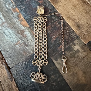 The DFB Co. (DF Briggs Company) gold filled or rolled gold antique pocket watch fob, clip and chain engraved ‘Calvin’