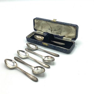 May include: Set of six silver teaspoons in a blue velvet lined box. The box has a label that reads "Thomas Johnson & Co. Sheffield England".
