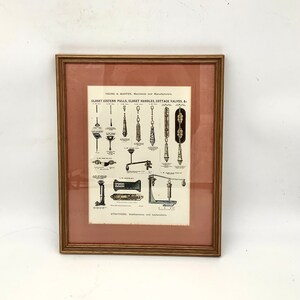 May include: A framed vintage advertisement for Young & Marten, Merchants and Manufacturers, featuring illustrations of various closet cistern pulls, closet handles, and cottage valves. The text reads "CLOSET CISTERN PULLS, CLOSET HANDLES, COTTAGE VALVES, &" and "STRATFORD, Walthamstow and Leytonstone."