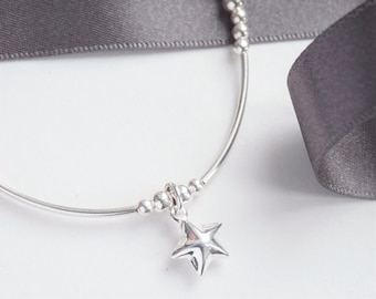 Sterling Silver stretch noodle bracelet with Puffed Star charm
