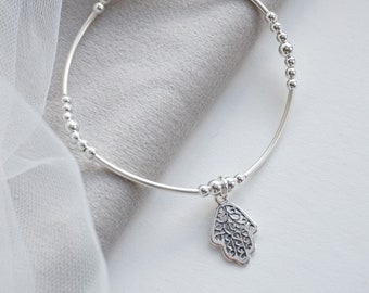 Sterling Silver stretch noodle bracelet with the Hamsa Hand charm