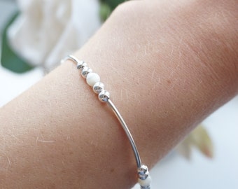 Sterling Silver stretch noodle bracelet with Mother of Pearl beads