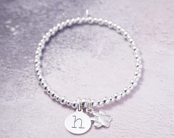 Sterling Silver stretch bracelet with 1 Lowercase Initial charm and Paw charm