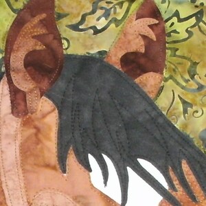 May include: A close-up of a brown and black horse's head with a black mane and a white muzzle. The horse's ears are pointed and the background is a blurry floral pattern.
