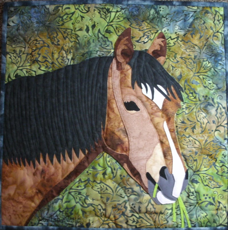 May include: A close-up of a brown and white horse's head with a black mane. The horse is looking to the right and has a green leafy stem in its mouth. The background is a green and brown floral pattern.