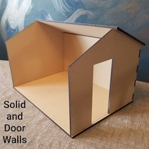 May include: A cardboard dollhouse with a brown roof and a door opening. The dollhouse has a solid wall on one side and a door opening on the other side. The text "Solid and Door Walls" is visible in the image.