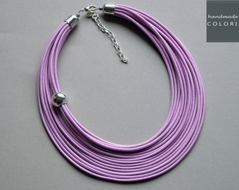 May include: A multi-strand lilac leather necklace with a silver clasp and a silver bead accent. Handmade by Colorika.