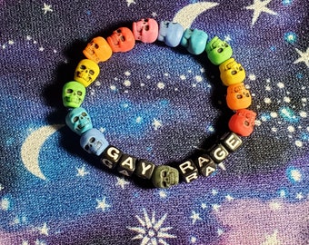 May include: A rainbow skull bead bracelet with the words "GAY RAGE" spelled out in black letter beads.