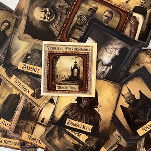 May include: A set of vintage-style oracle cards with illustrations of various characters and scenes. The cards feature a dark, gothic aesthetic and include titles such as "Banshee", "Boogeyman", "Unknown", and "Portal". The cards are part of a "Victorian Phantasmagoria Oracle Deck".