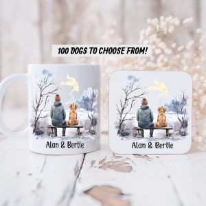 May include: White ceramic mug and coaster set with a watercolor illustration of a person and a dog sitting on a bench in a winter scene. The text "Alan & Bertie" is printed on both the mug and coaster.