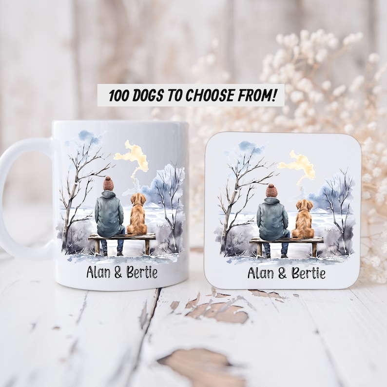 May include: White ceramic mug and coaster set with a watercolor illustration of a person and a dog sitting on a bench in a winter scene. The text "Alan & Bertie" is printed on both the mug and coaster.