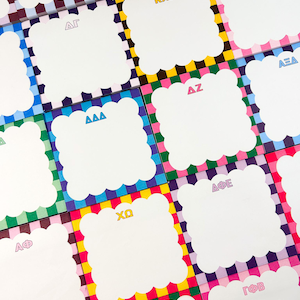 May include: A collection of white, scalloped-edge notepads with colorful checkered borders. Each notepad features Greek letters in various colors, including yellow, blue, and pink. The background is a vibrant mix of pink, green, blue, and yellow squares.
