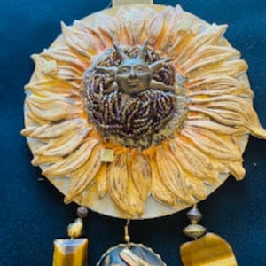 Altered Tin Sunflower in made from a repurposed tin, smashed, painted, and sanded and embellished with upcycled items.