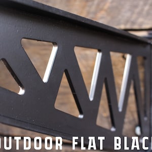 May include: Black metal shelf bracket with a triangular cut-out design. The bracket is labelled "OUTDOOR FLAT BLACK".
