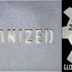 May include: A close-up of a galvanized metal sheet with the word "GALVANIZED" cut out. Next to it is a gear-shaped metal piece with the words "MAKER TABLE METAL" and a logo. The text "GALVI GLOSS CLEAR" is also visible.