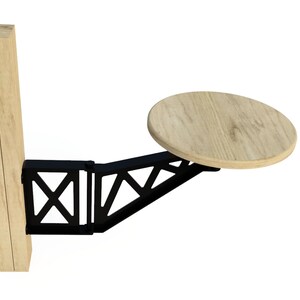 Puede incluir: Una mesa de madera con una tapa redonda que se fija a un soporte de metal negro. El soporte est&aacute; unido a un poste de madera.