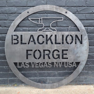 May include: A circular metal sign with the text "Blacklion Forge Las Vegas NV USA" and a stylised image of an anvil.