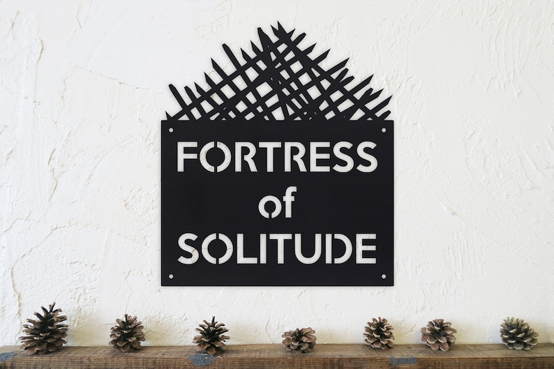 May include: Black metal sign with a white silhouette of a fortress and the text "Fortress of Solitude".