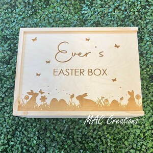 May include: A wooden box with a personalised inscription that reads "Ever's Easter Box". The box is decorated with a silhouette of bunnies, flowers, and eggs.