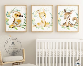 May include: Three framed watercolor prints featuring Australian animals: a kookaburra, a kangaroo, and a bilby. Each animal is surrounded by a green and yellow floral wreath. The prints are in light brown wooden frames, suitable for a nursery.