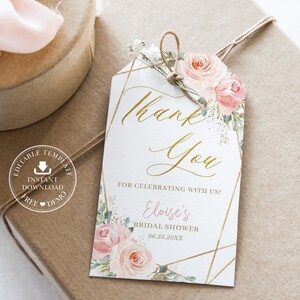May include: A white thank you tag with gold geometric accents and pink watercolor flowers. The text reads "Thank You" in gold script and "For celebrating with us! Eloise's Bridal Shower 06.25.20XX".