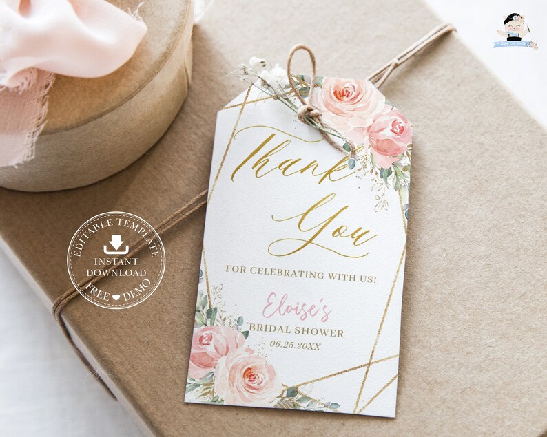 May include: A white thank you tag with gold geometric accents and pink watercolor flowers. The text reads "Thank You" in gold script and "For celebrating with us! Eloise's Bridal Shower 06.25.20XX".