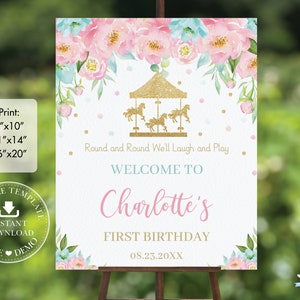 May include: A printable sign for a first birthday party with a pink and blue floral design. The sign features a gold glitter carousel with the text "Round and Round We'll Laugh and Play" and "Welcome to Charlotte's First Birthday 08.23.20XX".