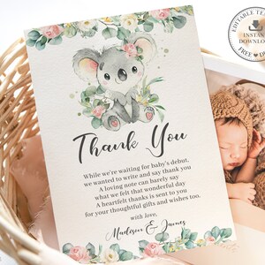 May include: A baby shower thank you card featuring a watercolor illustration of a gray koala surrounded by flowers and greenery. The card includes the text "Thank You" and a personalized message. A photo of a sleeping baby is also included.