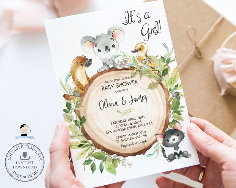 May include: A baby shower invitation with a watercolor illustration of a koala, a platypus, a kookaburra, and a Tasmanian devil. The invitation is on a woodgrain background with green leaves and the text "It's a Girl!" and "Please join us for a Baby Shower honoring Olivia & James".