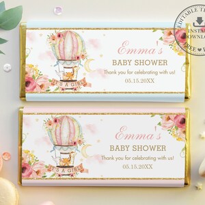 May include: Two pink and blue chocolate bar wrappers with a hot air balloon design. The wrappers feature a floral design, a hot air balloon with a basket, and the text "Emma's Baby Shower" and "It's a Girl!"