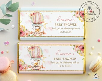 May include: Two pink and blue chocolate bar wrappers with a hot air balloon design. The wrappers feature a floral design, a hot air balloon with a basket, and the text "Emma's Baby Shower" and "It's a Girl!"