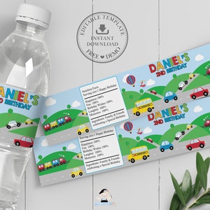 May include: Water bottle with a custom label for a 2nd birthday. The label features a blue sky, green hills, roads, and colorful vehicles like cars, a school bus, and an ambulance. The text "DANIEL'S 2ND BIRTHDAY" is prominently displayed.