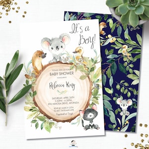 May include: A baby shower invitation with a blue and green woodland theme. The invitation features a koala, a platypus, a kookaburra, and a quokka. The text on the invitation reads "It's a Boy!" and "Please join us for a baby shower honoring Rebecca Ring".