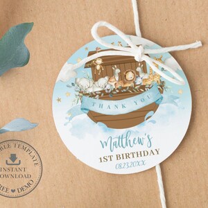 May include: Round blue and brown thank you tag with a watercolor illustration of Noah's Ark with animals. The tag says "Thank You" and "Matthew's 1st Birthday 08.23.20XX".