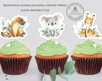 May include: Six printable cupcake toppers featuring Australian animals. The toppers include a koala, a kangaroo, and a platypus. Each topper is surrounded by green leaves and has a white heart on the bottom.