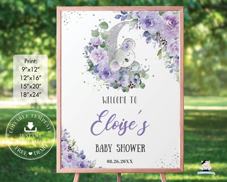 Op de afbeelding: Een babyborrelbord met een ros&eacute;gouden frame. Het bord heeft een aquarelontwerp met een slapende koala op een zilveren maan, omringd door paarse bloemen. De tekst luidt "Welkom bij Eloise's Baby Shower" en de datum.