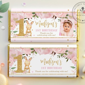 May include: Pink and gold chocolate bar wrapper with a floral design and a picture of a baby girl. The wrapper says "Madison's 1st Birthday" and "Thank you for celebrating with me!"