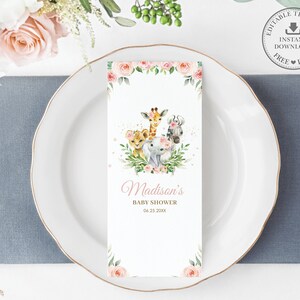 May include: A white baby shower invitation card with illustrations of a lion, giraffe, elephant, and monkey. The card reads "Madison's Baby Shower" and the date. The design is completed with floral accents and a decorative border.
