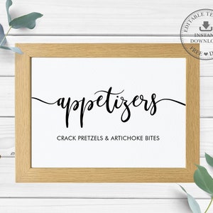 Puede incluir: Un cartel imprimible en un marco de madera con el texto "appetizers" en una fuente cursiva. El texto "Crack Pretzels & Artichoke Bites" está impreso debajo de la palabra "appetizers".
