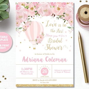 May include: Pink and gold bridal shower invitation with a hot air balloon and floral design. The text reads "Love is in the Air!" and "Please join us for a Bridal Shower".