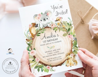 May include: A printable invitation for a 1st birthday party with a woodland theme. The invitation features a koala, a platypus, a bird, and a hedgehog surrounded by flowers and greenery. The text on the invitation reads "You're Invited", "Amelia's 1st Birthday", "Please join us to celebrate", "Saturday, April 26th", "3:30pm - 6:30pm", "896 Mimosa Drive, Avonlea", "RSVP by March 25th", "To Bec 0432 659 698".