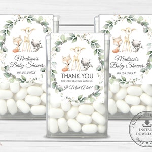 May include: Three clear plastic containers of mints with labels featuring a watercolour illustration of a deer, fox, and raccoon surrounded by greenery. The labels also include the text "Madison's Baby Shower" and the date "08.25.20XX". One label says "Thank You for celebrating with us! It Mint A lot!"