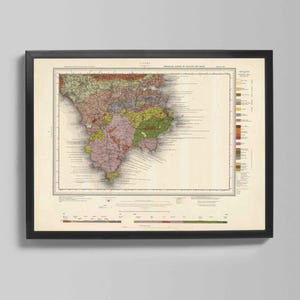 May include: Framed vintage map print showing a detailed geological survey of a region, with a colour-coded representation of the terrain. The map is set in a black frame, against a neutral background. The map's colours include shades of green, brown, and pink.