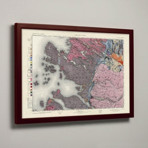 May include: A framed map of a geological region with a color-coded key. The map shows various rock formations and geological features. The map is framed in a dark wood frame.